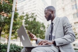 Businessman using smartphone and laptop as Meta Muse brings AI agents mainstream
