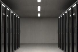 Data center corridor representing AI agent infrastructure at scale